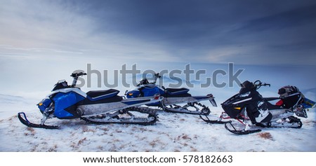 Snowmoblies in beautiful snow scenery
