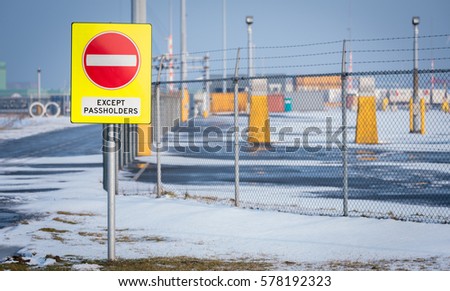Stop Sign "except Passholders" in front of an Industrial ISPS (International Ship and Port facility Security Code, ISPS-code) terrain.