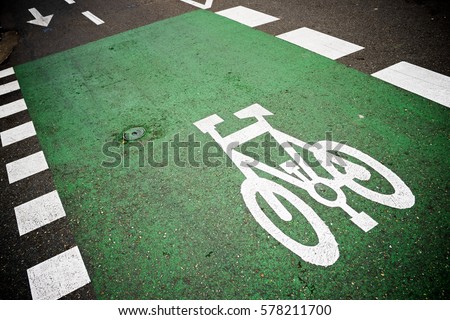 Bike lane sign painted on a street.