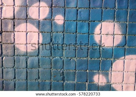 Painted mosaic brick tile wall, close up of graffiti texture, with vibrant colors for creativity, imaginative backgrounds and ideas. Grunge and urban.