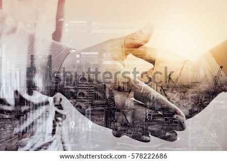 Double exposure of Business partnership meeting concept.photo businessman handshake. Successful businessmen handshaking after perfect deal.close up,London architecture city