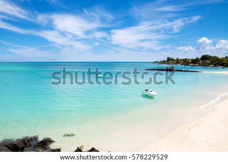 Beautiful amazing nature background. Boat in tropical blue sun sea. Luxury holiday resort. Mauritius island Royalty-Free Stock Photo #578229529