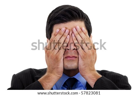 Stock image of businessman covering his eyes with his hands, over white background
