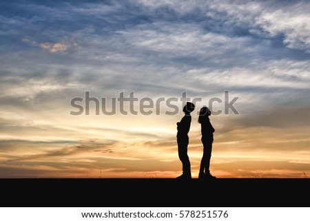Divorce family - Silhouette of Shadow couples. Women dispute with man about disagreement in young married couples. Anger young couple having quarrel. lover standing opposite in the sunset background.