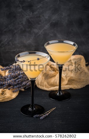Lemonade martini with lavender on dark background