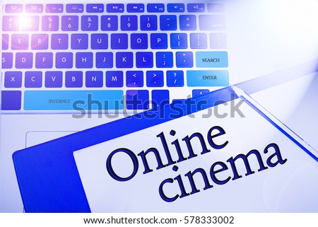 Online cinema word in business concepts, technology background in laptop and notepad