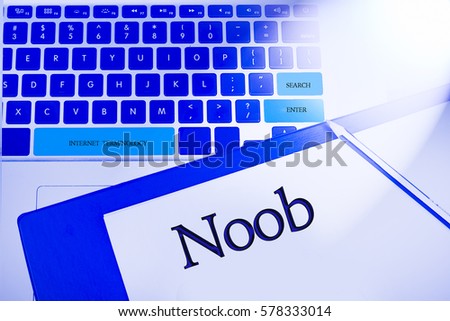 Noob word in business concepts, technology background in laptop and notepad