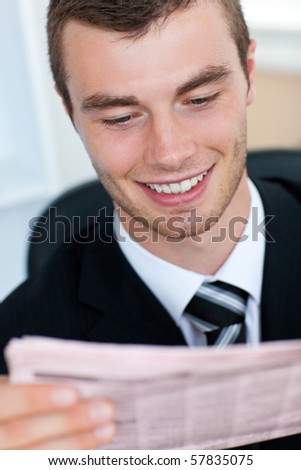 Radiant businessman reading newspaper in office