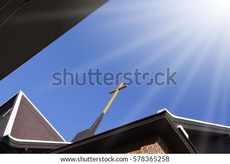 Christian religious image of a cross on top of a church with copy space  with light of hope.