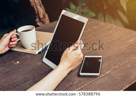 Close up of women hand holding tablet computer with blank copy space screen for your advertising. 