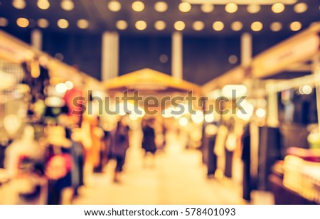 Abstract Blur image of Shopping Mall or  Exhibition Hall and people for background usage . (vintage tone)