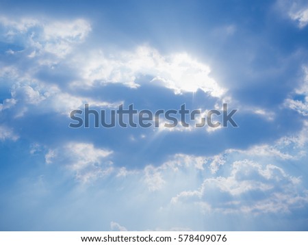 View of sunlight on blue sky background with white cloud