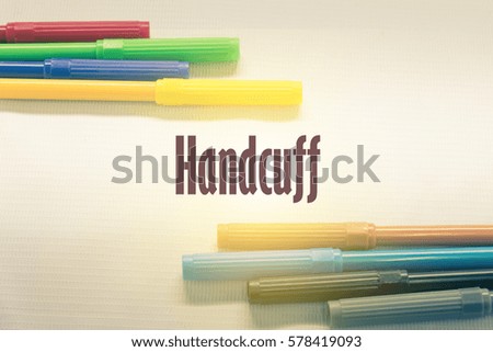 Handcuff  - Abstract hand writing word to represent the meaning of word as concept. The word Handcuff is a part of Action Vocabulary Words in stock photo.