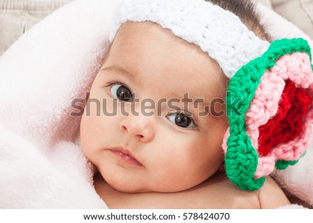 Baby girl wearing a crocheted headband