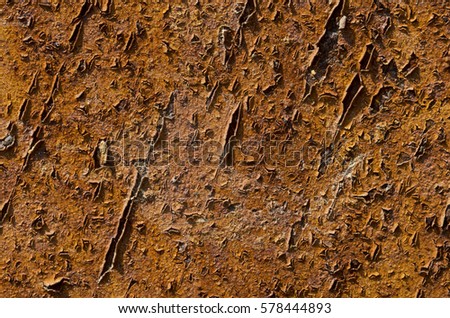 Red, rusty background with peeling paint.