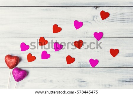 Valentines day concept with red and pink hearts over light wooden background