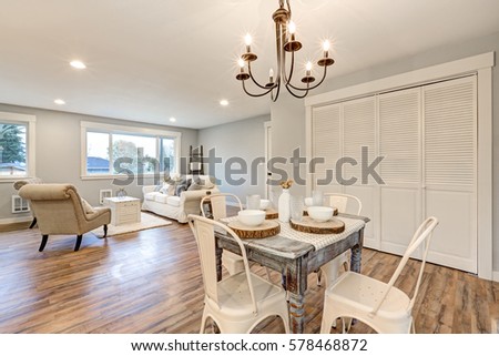 Newly remodeled one story craftsman home interior. Dining area boasts white washed dining table with four chairs next to living room. Northwest, USA