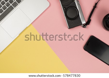 Flat lay style picture of workspace with office supplies on pastel colored background. Top view