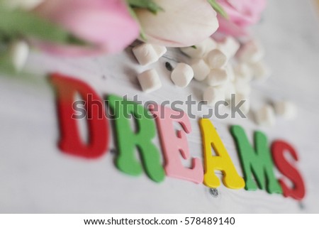 Concept dreams background. Dreams wooden letters with tulips. Spring dreams. 