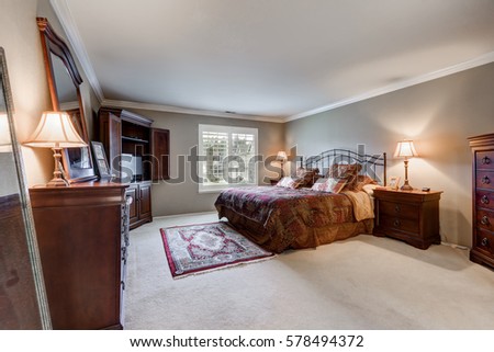 Master bedroom interior with vintage furniture set in American colonial home. Northwest, USA