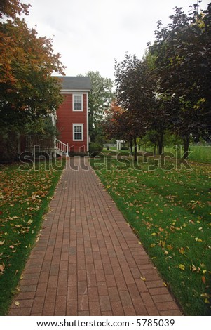                   a picture of brick pavement leading to side of ride house in middle autumn,