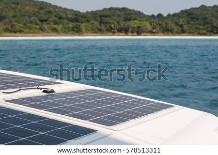 Solar charging batteries aboard a sail boat. Photovoltaic panels renewable eco energy concept Royalty-Free Stock Photo #578513311