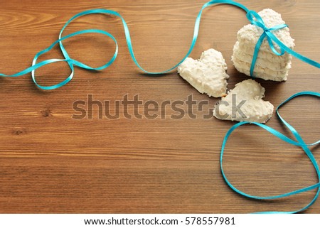 cookies in the shape of a heart tied with a ribbon on a wooden background. Valenitina Holy Day. Mothers Day. Romantic background.