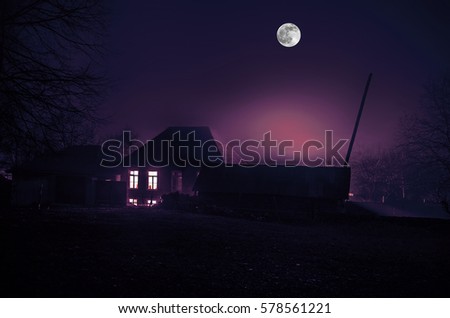 house in fog at night in the garden, Landscape of ghost house in the dark forest. Horror concept with big full moon