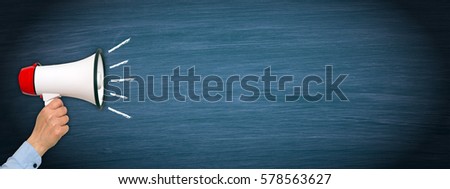 Megaphone with hand on blue chalkboard background with copy space for individual text Royalty-Free Stock Photo #578563627