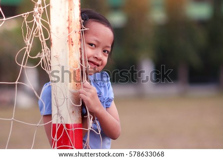 Portrait of smile child girl in football field.