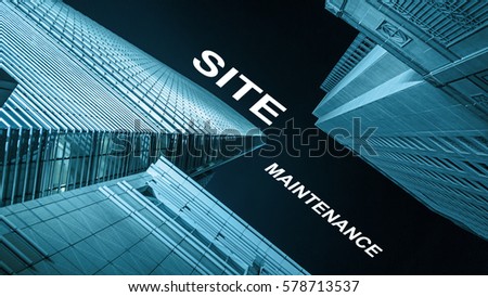 Modern buildings from low angle at night with text site maintenance.