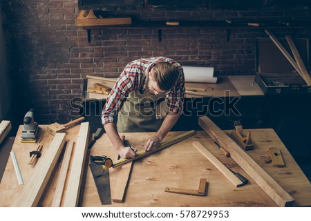 handsome joiner work in carpentry.  He is successful entrepreneur at his workplace. Royalty-Free Stock Photo #578729953