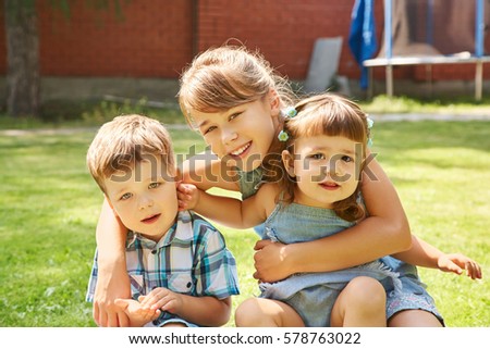 happy playful children outdoors in the summer on the grass in a backyard