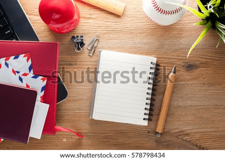 wooden desktop with blank notebook paper background