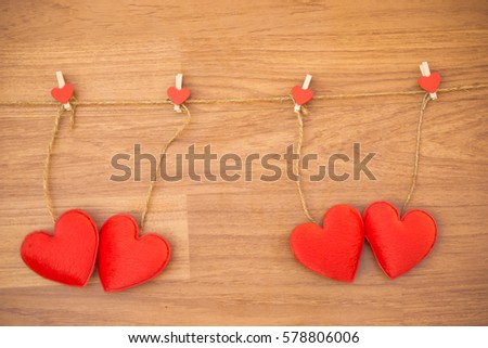 gingham love valentine hearts natural cord and red clips hanging on wood background