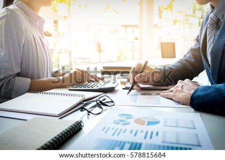 business man financial inspector and secretary making report, calculating or checking balance. Internal Revenue Service inspector checking document. Audit concept Royalty-Free Stock Photo #578815684