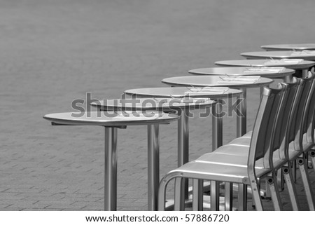 Empty cafe tables in paris with copy space - Black and white