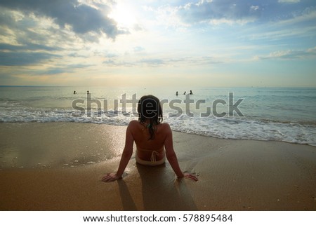 Girl on the shore of the sea back