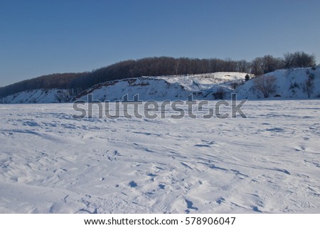 Bright frosty winter day. Frozen River Volga. The minimalist landscape. Ice desert. Ulyanovsk, Russia.