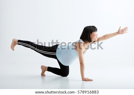 Asian pregnant woman exercise sport,White background in studio
