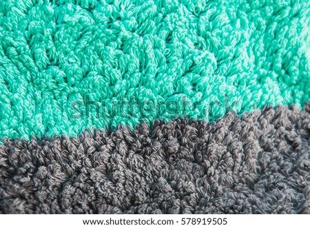 Texture of streaked green terry towel, macro. Selective focus