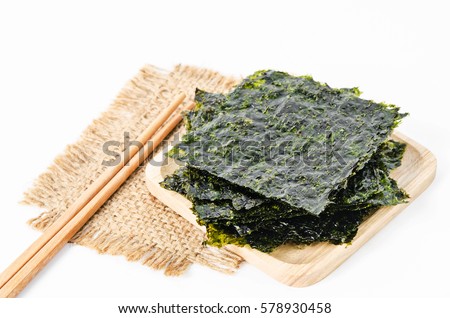Japanese food nori dry seaweed sheets with salt and chopsticks on white background. Royalty-Free Stock Photo #578930458