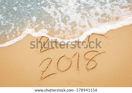 New Year 2018 replace 2017 on sea beach summer, New Year 2017 is coming concept. Closeup. Royalty-Free Stock Photo #578941156