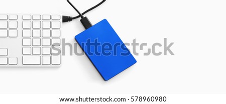 top view of external harddisk and keyboard on white background with copy space