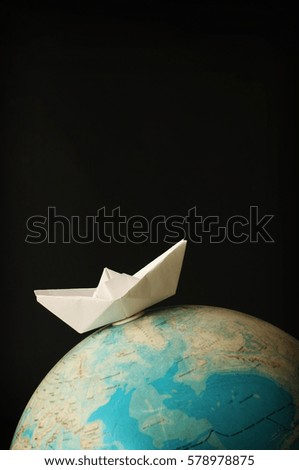 Travel concept with paper boat