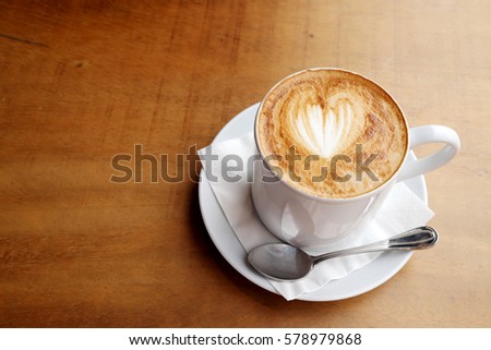 Hot latte on a wooden table