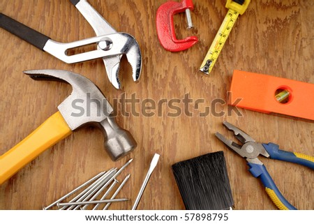 Assorted tools on wooden panel Royalty-Free Stock Photo #57898795