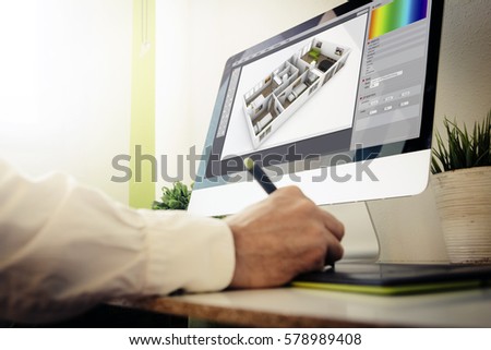 interior designer working with computer. All screen graphics are made up.