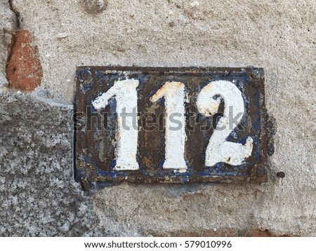 Vintage grunge square metal rusty plate of number of street address