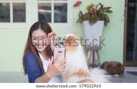 Dog was playing with the master,while she was taking a picture, selfie.